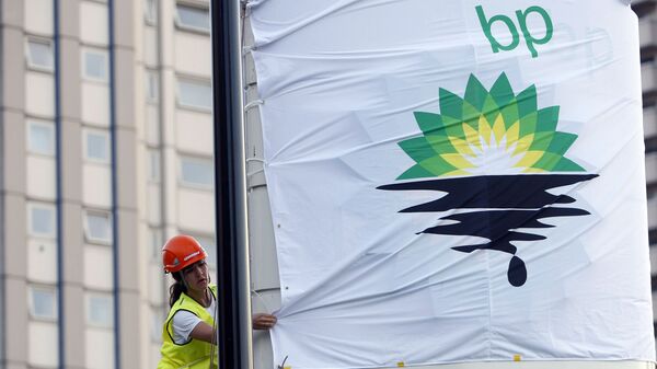 In this Tuesday, July 27, 2010, file photo, a Greenpeace activist puts up a banner as they block off a British Petroleum fuel station in protest as the BP board announce their annual results, in London - Sputnik International