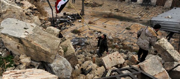 A member of forces loyal to Syria's President Bashar al-Assad attempts to erect the Syrian national flag inside the Umayyad mosque, in the government-controlled area of Aleppo, during a media tour, Syria December 13, 2016 A member of forces loyal to Syria's President Bashar al-Assad attempts to erect the Syrian national flag inside the Umayyad mosque, in the government-controlled area of Aleppo, during a media tour, Syria December 13, 2016 - Sputnik International