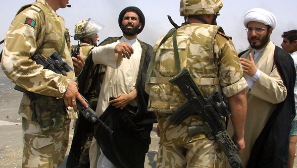 Iraqi clerks talk to British soldiers as clashes broke out in the southern city of Basra 09 August 2003 over fuel shortages and lack of electricity. - Sputnik International