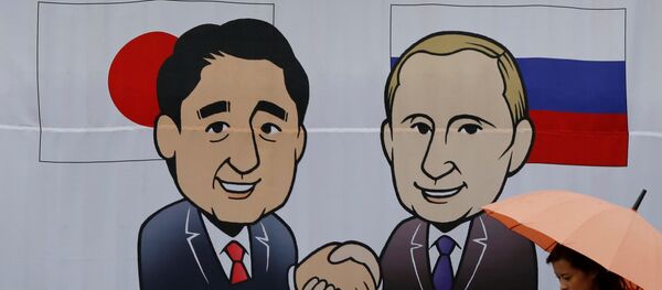 A woman walks past a banner showing Japan's Prime Minister Shinzo Abe and Russian President Vladimir Putin at the Senzaki station in Nagato, Yamaguchi prefecture, Japan, December 14, 2016 A woman walks past a banner showing Japan's Prime Minister Shinzo Abe and Russian President Vladimir Putin at the Senzaki station in Nagato, Yamaguchi prefecture, Japan, December 14, 2016 - Sputnik International