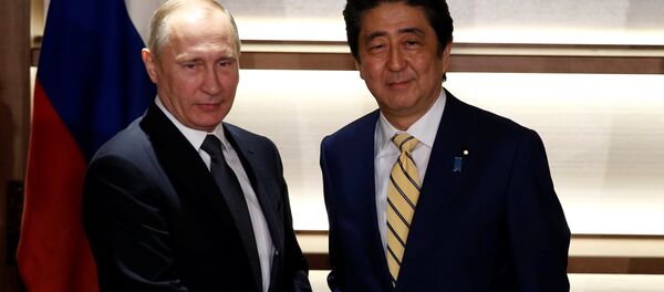 Russia's President Vladimir Putin (L) shakes hands with Japan's Prime Minister Shinzo Abe at the start of their summit meeting in Nagato, Yamaguchi prefecture, Japan, December 15, 2016. Russia's President Vladimir Putin (L) shakes hands with Japan's Prime Minister Shinzo Abe at the start of their summit meeting in Nagato, Yamaguchi prefecture, Japan, December 15, 2016. - Sputnik International