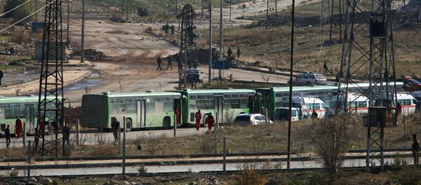 Buses and ambulances wait to evacuate civilians and rebels from eastern Aleppo, Syria December 15, 2016. Buses and ambulances wait to evacuate civilians and rebels from eastern Aleppo, Syria December 15, 2016. - Sputnik International