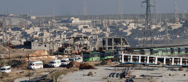 Ambulances and buses evacuating people drive out of a rebel-held part of Aleppo, Syria December 15, 2016. Ambulances and buses evacuating people drive out of a rebel-held part of Aleppo, Syria December 15, 2016. - Sputnik International