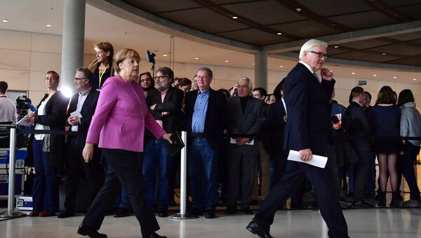 German Chancellor Angela Merkel (R) and Frank-Walter Steinmeier leave after a press conference together with the presidents of the ruling coalition Sigmar Gabriel (SPD)(Unseen) and Horst Seehofer (CSU)(Unseen) to present Frank-Walter Steinmeier as their candidate for German president on November 16, 2016 at the German lower house of parliament (the Bundestag) in Berlin. - Sputnik International