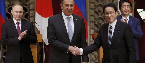 Russian President Vladimir Putin, left, and Japanese Prime Minister Shinzo Abe, rear right, applaud as Russian Foreign Minister Sergey Lavrov, second left, and his Japanese counterpart Fumio Kishida shake hands after exchanging the signed agreement in Tokyo, Japan, Friday, Dec. 16, 2016. Russian President Vladimir Putin, left, and Japanese Prime Minister Shinzo Abe, rear right, applaud as Russian Foreign Minister Sergey Lavrov, second left, and his Japanese counterpart Fumio Kishida shake hands after exchanging the signed agreement in Tokyo, Japan, Friday, Dec. 16, 2016. - Sputnik International