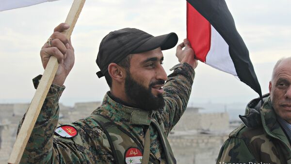 Syrian Arab Army soldier, celebrating liberation of Sheikh Saeed, East Aleppo from Nusra Front led occupation. - Sputnik International