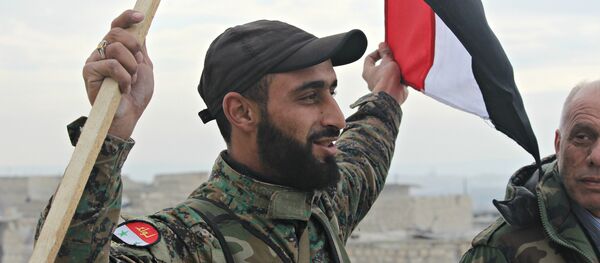 Syrian Arab Army soldier, celebrating liberation of Sheikh Saeed, East Aleppo from Nusra Front led occupation. - Sputnik International