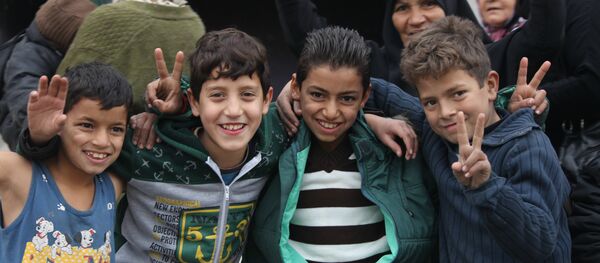 Children celebrating liberation in Hanano, East Aleppo Children celebrating liberation in Hanano, East Aleppo - Sputnik International