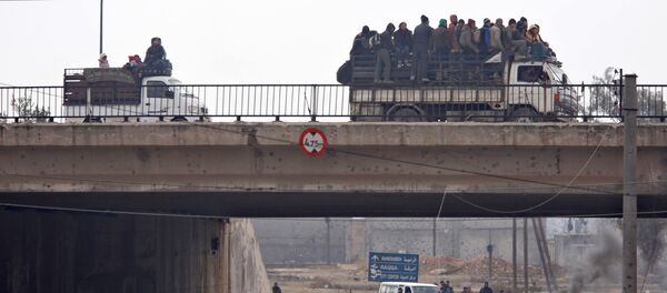 Evacuees from rebel-held eastern Aleppo ride on pick-up trucks along the government-held area of al-Ramousah bridge, Syria December 16, 2016. - Sputnik International
