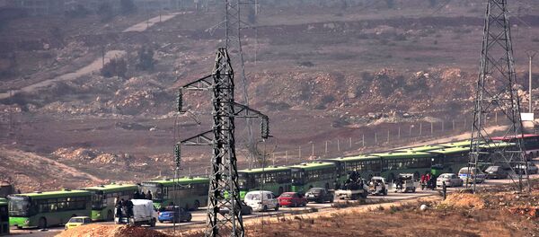 Buses are seen during an evacuation operation of Syrian rebel fighters and civilians from a opposition-held area of Aleppo towards rebel-held territory in the west of Aleppo's province Buses are seen during an evacuation operation of Syrian rebel fighters and civilians from a opposition-held area of Aleppo towards rebel-held territory in the west of Aleppo's province - Sputnik International