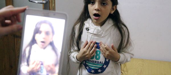 Syrian Bana al-Abed is filmed by her mother as they prepare to post on Twitter in English about life in the besieged eastern districts of Syria's Aleppo, on October 12, 2016. - Sputnik International