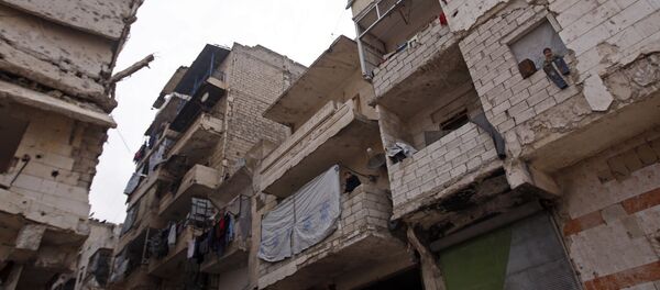 Residents in a government-held part of Aleppo's Salaheddin neighbourhood look out from the balconies of their damaged houses at the road on which the convoy evacuating civilians and rebel fighters from the last rebel-held neighbourhood in the northern Syrian city were supposed to pass Residents in a government-held part of Aleppo's Salaheddin neighbourhood look out from the balconies of their damaged houses at the road on which the convoy evacuating civilians and rebel fighters from the last rebel-held neighbourhood in the northern Syrian city were supposed to pass - Sputnik International
