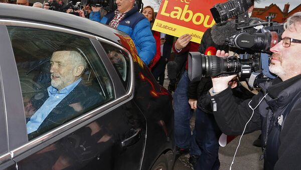 British opposition Labour Party leader Jeremy Corbyn (L) leaves in a car after speaking to the media following Labour candidate Jim McMahon's victory in the by-election for Oldham West and Royton outside Chadderton Town Hall in Chadderton, Oldham, northwest England, on December 4, 2015. - Sputnik International