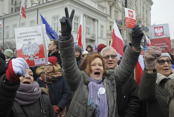 Protesters holding copies of Poland's constitution shout slogans during an anti-government demonstration, in Warsaw, Poland Protesters holding copies of Poland's constitution shout slogans during an anti-government demonstration, in Warsaw, Poland - Sputnik International