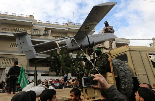 Palestinian militants of the Ezzedine al-Qassam Brigades, Hamas' armed wing, dislpay a drone during a parade marking the 27th anniversary of the Islamist movement’s creation on December 14, 2014 in Gaza City Palestinian militants of the Ezzedine al-Qassam Brigades, Hamas' armed wing, dislpay a drone during a parade marking the 27th anniversary of the Islamist movement’s creation on December 14, 2014 in Gaza City - Sputnik International
