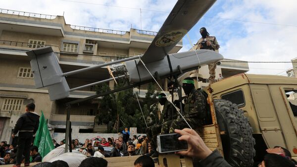 Palestinian militants of the Ezzedine al-Qassam Brigades, Hamas' armed wing, dislpay a drone during a parade marking the 27th anniversary of the Islamist movement’s creation on December 14, 2014 in Gaza City - Sputnik International
