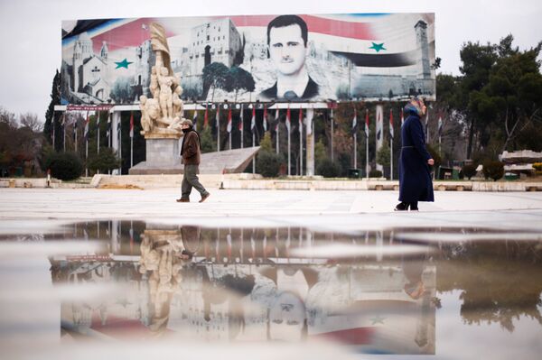 People walk past a billboard depicting Syria's President Bashar al-Assad at Saadallah al-Jabri Square, in the government controlled area of Aleppo, Syria December 17, 2016 People walk past a billboard depicting Syria's President Bashar al-Assad at Saadallah al-Jabri Square, in the government controlled area of Aleppo, Syria December 17, 2016 - Sputnik International