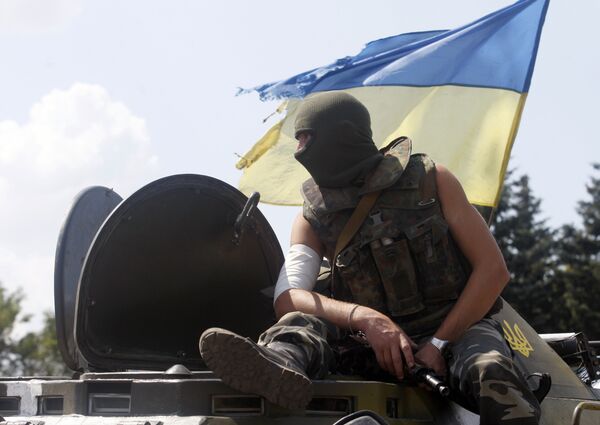 An Ukrainian soldier sits on the top of an APC at a checkpoint in the eastern city of Debaltsevo. File photo An Ukrainian soldier sits on the top of an APC at a checkpoint in the eastern city of Debaltsevo. File photo - Sputnik International