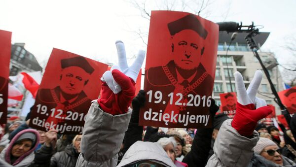 People hold signs with the image of Andrzej Rzeplinski, head of Poland's Constitutional Court, as they take part in demonstration in front of the Constitutional Tribunal in Warsaw, Poland December 18, 2016. - Sputnik International
