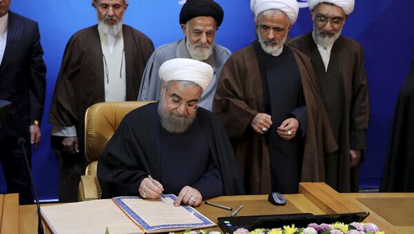 In this photo released by official website of the office of the Iranian Presidency, President Hassan Rouhani signs the document of Iran's Charter of Citizenship Rights. in a conference called Constitution and the Nation's Rights. in Tehran, Iran, Monday, Dec. 19, 2016 - Sputnik International