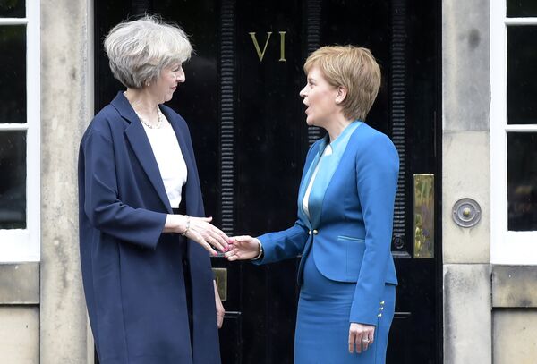 Britain's Prime Minister Theresa May (L) is greeted by Scotland's First Minister Nicola Sturgeon (R) as she arrives for talks at Bute House, in Edinburgh, on July 15, 2016. Britain's Prime Minister Theresa May (L) is greeted by Scotland's First Minister Nicola Sturgeon (R) as she arrives for talks at Bute House, in Edinburgh, on July 15, 2016. - Sputnik International
