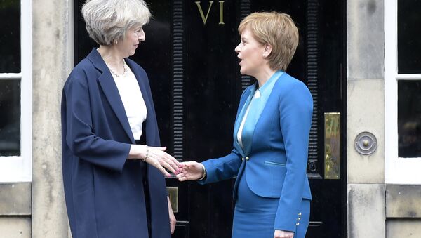 Britain's Prime Minister Theresa May (L) is greeted by Scotland's First Minister Nicola Sturgeon (R) as she arrives for talks at Bute House, in Edinburgh, on July 15, 2016. - Sputnik International