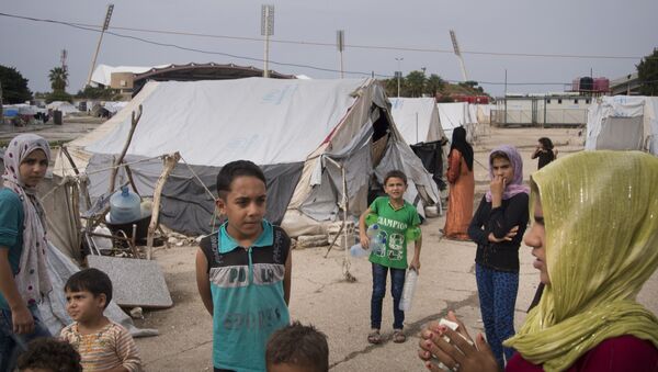 Refugees stand at a camp in Latakia, Syria - Sputnik International