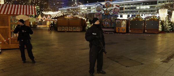 Police guard a Christmas market after a truck ran into the crowded Berlin Christmas market. Police guard a Christmas market after a truck ran into the crowded Berlin Christmas market. - Sputnik International
