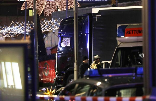 Police stand beside a damaged truck which ran into crowded Christmas market in Berlin, Germany. Police stand beside a damaged truck which ran into crowded Christmas market in Berlin, Germany. - Sputnik International