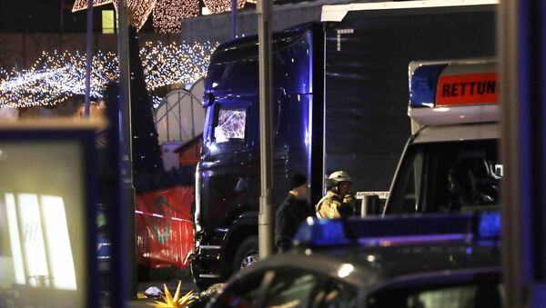 Police stand beside a damaged truck which ran into crowded Christmas market in Berlin, Germany. - Sputnik International