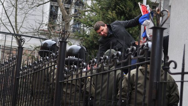 Independent MP of Ukraine's Supreme Rada Vladimir Parasyuk ripping off the Russian flag from the building of the Russian Consulate General in Lviv during a rally demanding liberation of Nadezhda Savchenko. File photo - Sputnik International