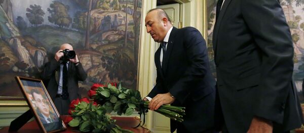 Russian Foreign Minister Sergei Lavrov (R) and his Turkish counterpart Mevlut Cavusoglu lay flowers in front of a photo of Russian ambassador to Turkey, who was killed in Ankara, before their talks in Moscow on December 20, 2016 Russian Foreign Minister Sergei Lavrov (R) and his Turkish counterpart Mevlut Cavusoglu lay flowers in front of a photo of Russian ambassador to Turkey, who was killed in Ankara, before their talks in Moscow on December 20, 2016 - Sputnik International