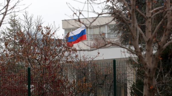 Russian flag flies at half mast in front of the Russian Embassy in Ankara on December 20, 2016, a day after the Russian Ambassador to Turkey was killed by a gunman - Sputnik International