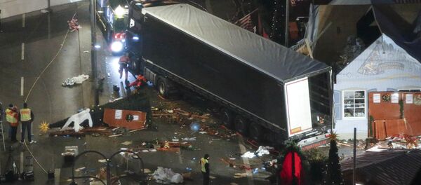 A used suit of a forensic investigator lies on a Christmas tree where a truck ploughed through a crowded Christmas market killing 12 people in the west of Berlin, Germany, December 20, 2016 - Sputnik International