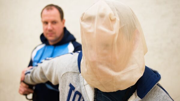 A man is restrained with a spit hood in a demonstration Herts Police - Sputnik International