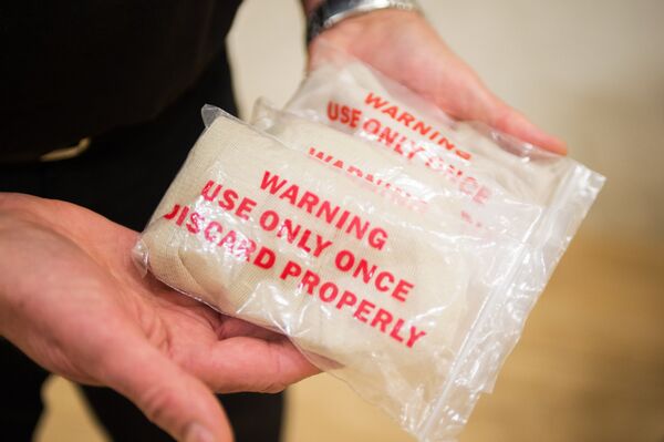 'Spit hoods' are meant to prevent potential offenders from spitting at police officers. 'Spit hoods' are meant to prevent potential offenders from spitting at police officers. - Sputnik International