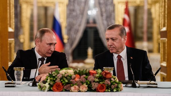 (FILES) This file photo taken on October 10, 2016 shows Russian President Vladimir Putin (L) speaking to Turkish President Recep Tayyip Erdogan (R) as they attend a press conference in Istanbul - Sputnik International