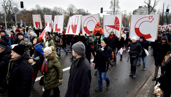 People hold signs of letters composing the word 'Freedom' as they march in an anti-government protest in Warsaw, Poland December 18, 2016. - Sputnik International