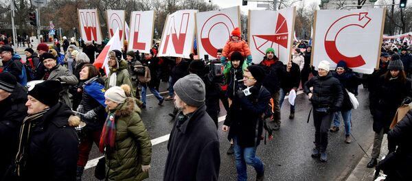 People hold signs of letters composing the word 'Freedom' as they march in an anti-government protest in Warsaw, Poland December 18, 2016. People hold signs of letters composing the word 'Freedom' as they march in an anti-government protest in Warsaw, Poland December 18, 2016. - Sputnik International