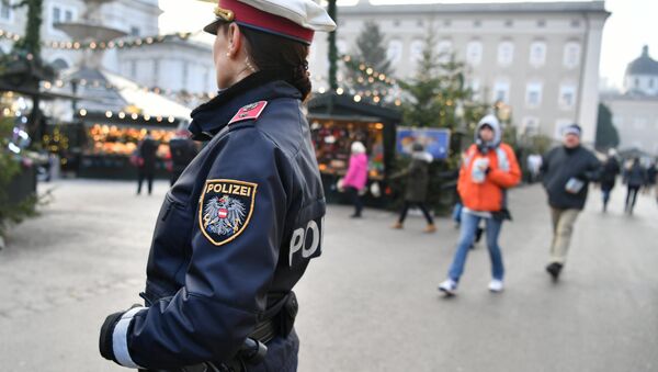 A policewoman patrols over a Christmas market in Salzburg on December 20, 2016, as security measures are taken after a deadly rampage by a lorry driver at a Berlin Christmas market - Sputnik International