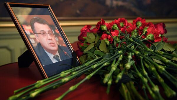 Flowers are placed in front of a portrait of Russian Ambassador to Turkey Andrei Karlov in the Foreign Ministry in Moscow a day after the assassination of the Russian ambassador in the Turkish capital - Sputnik International