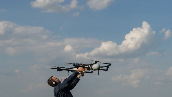 A man prepares to launch an unmanned aerial vehicles (UAV) during UAV demonstration flights. (File) - Sputnik International