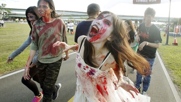 Runners dressed as zombies race during the Zombie Run Taiwan at the Fu Zhou Riverside Park in New Taipei City, Taiwan - Sputnik International