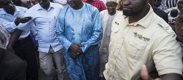 Gambia President elect, Adama Barrow, centre, walks after a meeting with Ecowas delegation in Banjul, Gambia, Tuesday, Dec. 13, 2016. Gambia's ruling party pressed for fresh elections, as West African regional mediators intervened Tuesday to try to resolve a political crisis in the tiny West African country that voted its leader of 22 years from power. (AP Photo/ Sylvain Cherkaoui) - Sputnik International