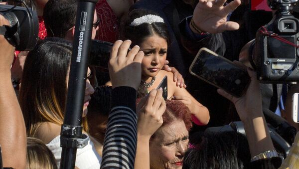 Rubi Ibarra arrives at the site of a Mass that is part of her down-home 15th birthday party, surrounded by a horde of journalists, in the village of La Joya, San Luis Potosi State, Mexico, Monday, Dec. 26, 2016 - Sputnik International