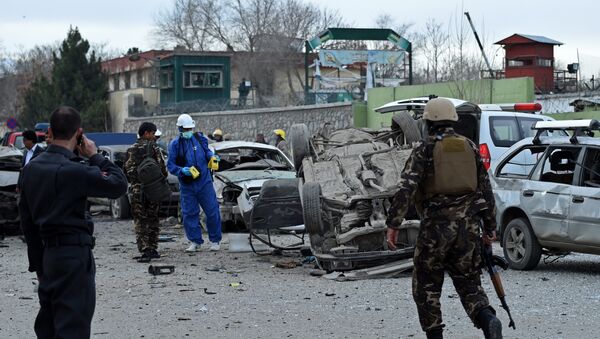 Afghan police and security personnel inspect the scene of a suicide car bomb attack near a district police headquarters in the centre of the Afghan capital Kabul - Sputnik International
