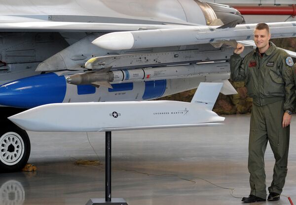 A Polish Air Force pilot looks at a model of a JASSM missile prior to a contract signing ceremony of 40 Lockheed Martin’s joint air-to-surface standoff missiles (JASSM), as well as F-16 fighter plane operational flight plan upgrades, associated equipment, parts, training and logistical support, between Poland and U.S., at a Polish Air Force base in Poznan, Poland, Thursday, Dec. 11, 2014 A Polish Air Force pilot looks at a model of a JASSM missile prior to a contract signing ceremony of 40 Lockheed Martin’s joint air-to-surface standoff missiles (JASSM), as well as F-16 fighter plane operational flight plan upgrades, associated equipment, parts, training and logistical support, between Poland and U.S., at a Polish Air Force base in Poznan, Poland, Thursday, Dec. 11, 2014 - Sputnik International
