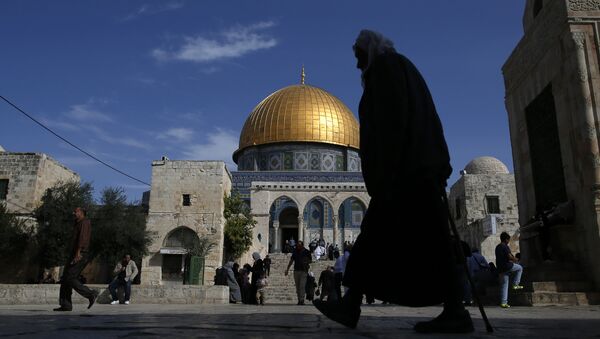 A Palestinian man walks past the Dome of Rock at the Al-Aqsa Mosque compound after the Friday prayer in Jerusalem's Old City on November 11, 2016 - Sputnik International