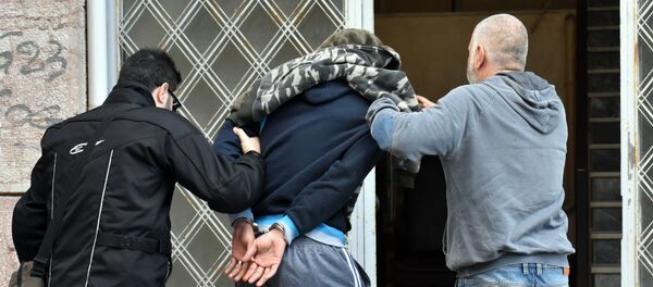 A Syrian man is escorted by police officers before a prosecutor on the island of Chios on December 14, 2016 after being suspected of brutally beating a three-year-old refugee boy in a camp shower A Syrian man is escorted by police officers before a prosecutor on the island of Chios on December 14, 2016 after being suspected of brutally beating a three-year-old refugee boy in a camp shower - Sputnik International