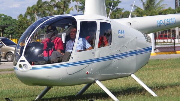 Then-local mayor of Davao city Rodrigo Duterte (R), aboard a helicopter, arrives at the provincial capitol in Tagum city, Davao del Norte, southern Philippines for the Regional Peace and Order Council meeting, April 20, 2015 - Sputnik International